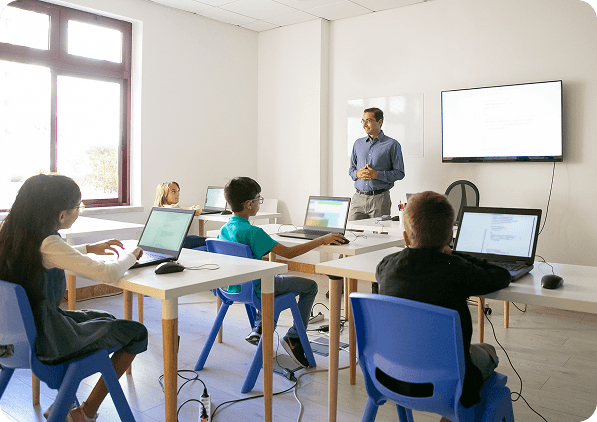 Teacher helping students in classroom
